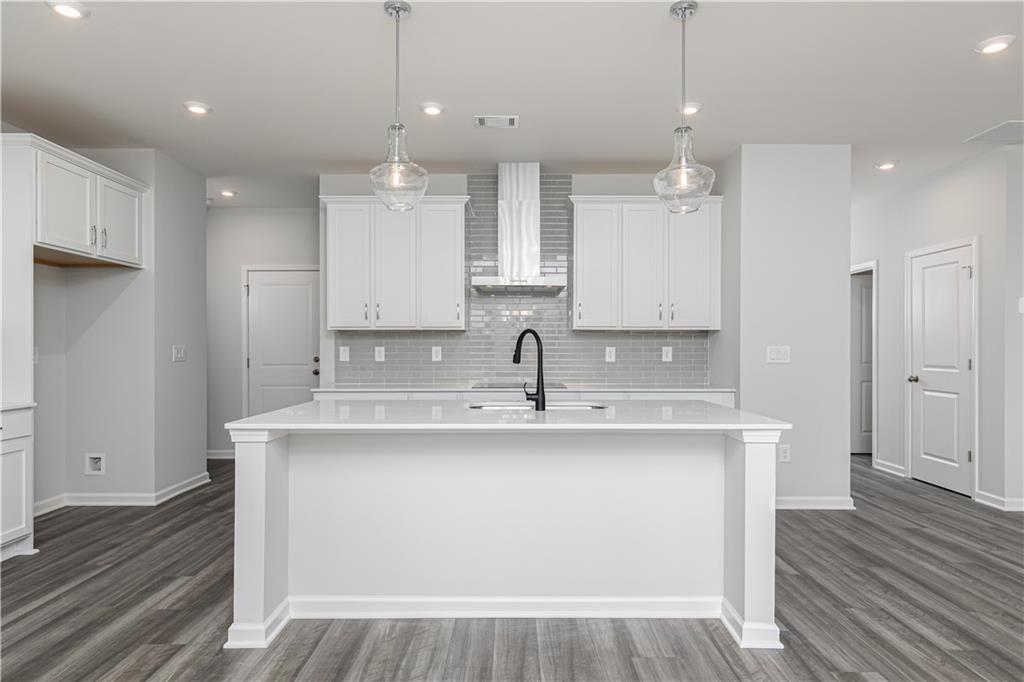 329 Cavalier Lane Acworth, GA 30102 - Photo 5 of 58 a view of a kitchen counter space with wooden floor and staircase