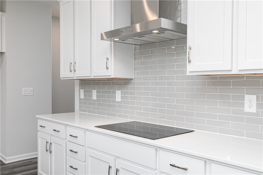 329 Cavalier Lane Acworth, GA 30102 - Photo 7 of 58 a kitchen with granite countertop white cabinets and a stainless steel appliances