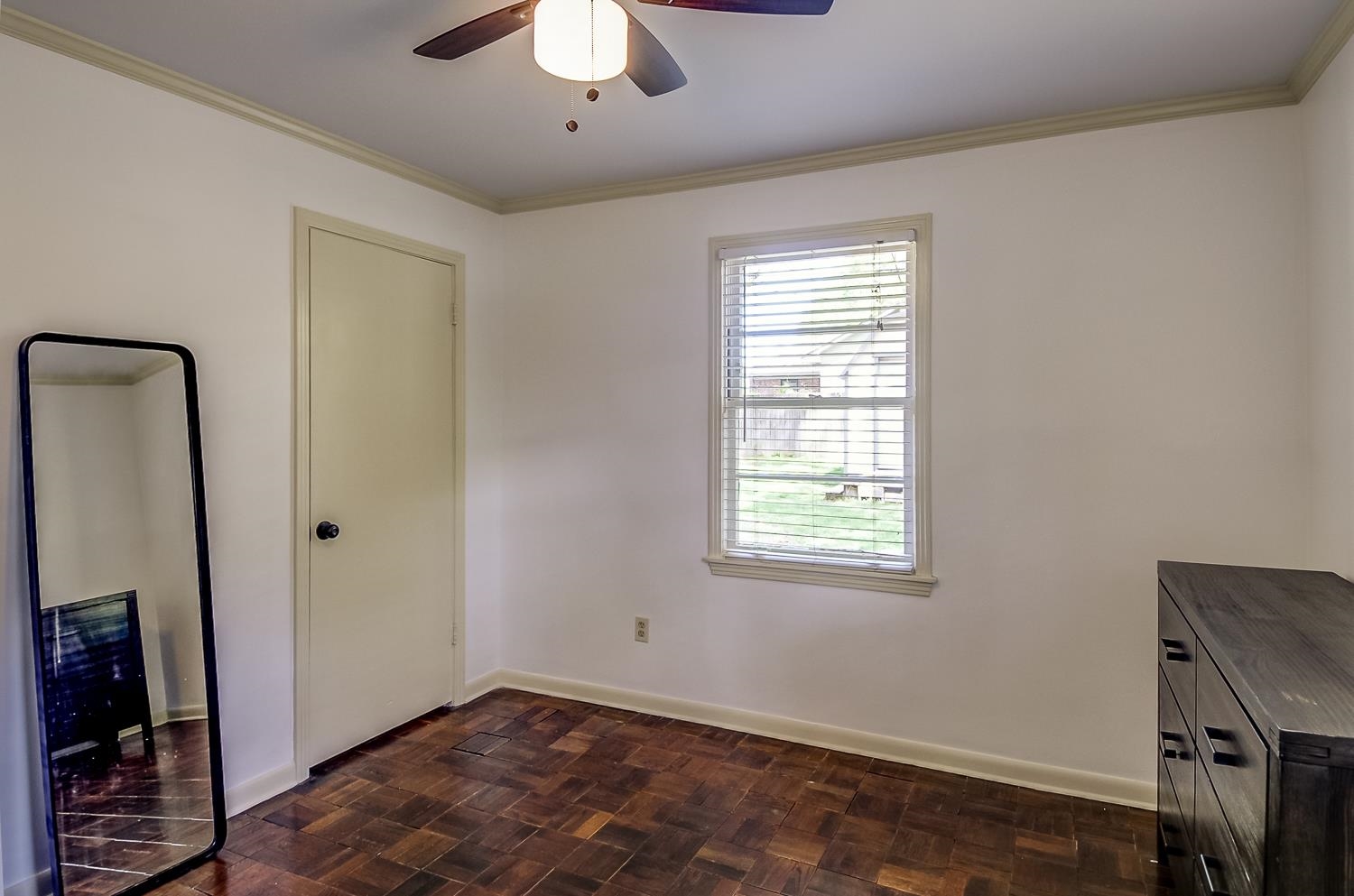 5056 Wingdale Road Memphis, TN 38117 - Photo 16 of 18 Unfurnished bedroom with parquet floors, ornamental molding, and ceiling fan
