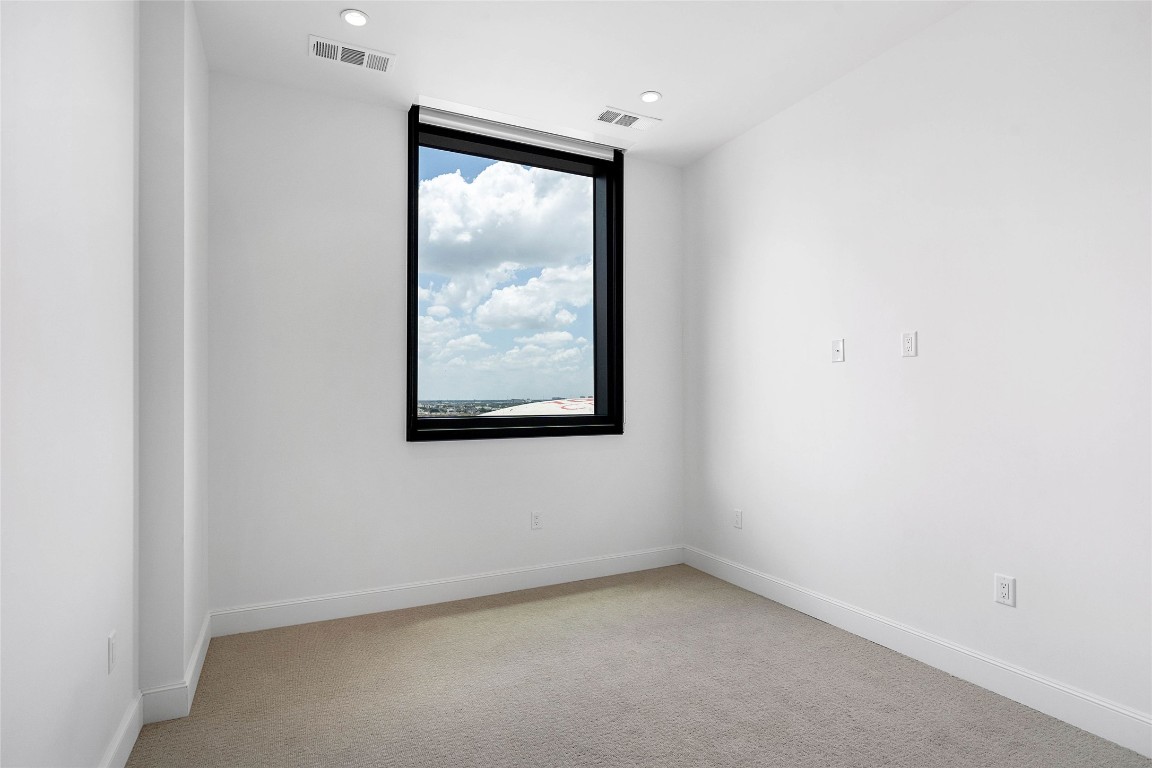 1211 Caroline Street, Unit 1102 Houston, TX 77002 - Photo 7 of 9 an empty room with a window
