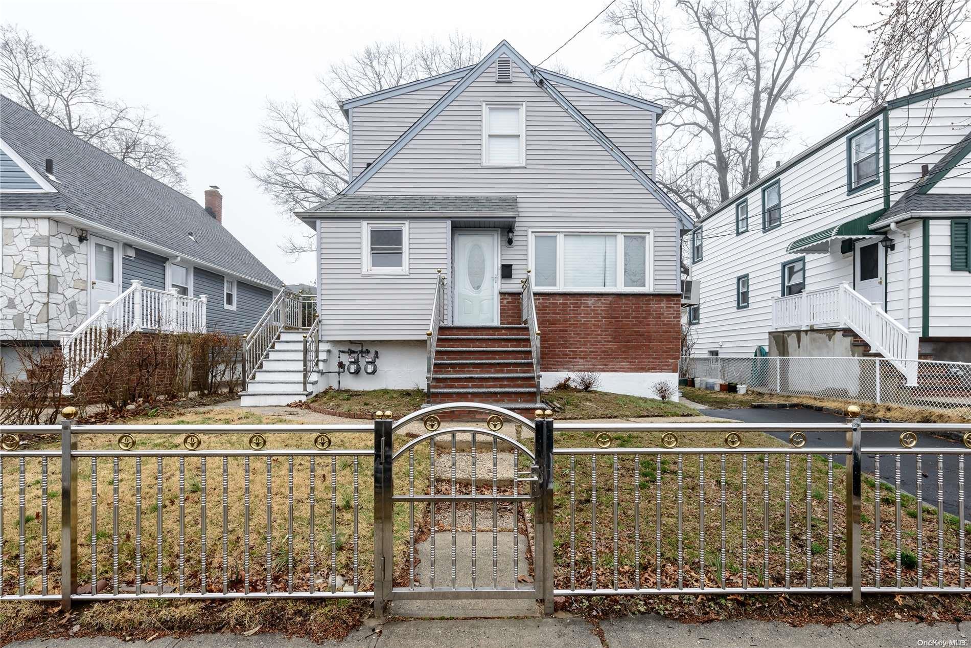49 Hickory Road Port Washington, NY 11050 - Photo 1 of 1 a front view of a house with balcony