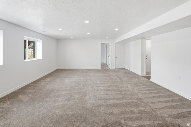 3636 West 910 South Syracuse, UT 84075 - Photo 50 of 70 Spacious lower-level room featuring light gray carpeting, recessed lighting, white walls, and two white-framed windows