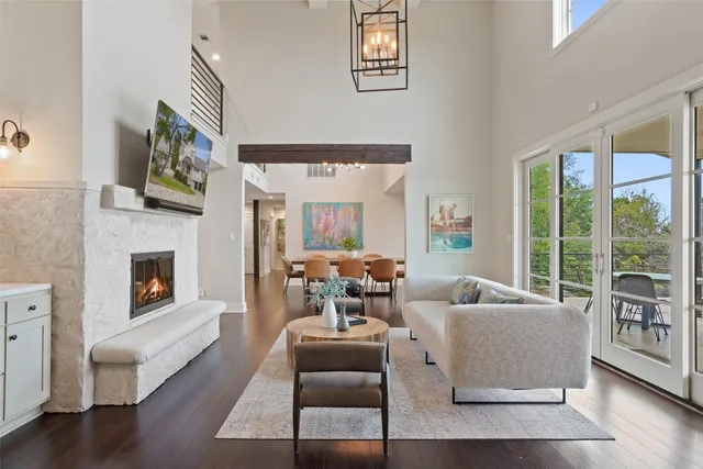 a living room with furniture large window and fireplace