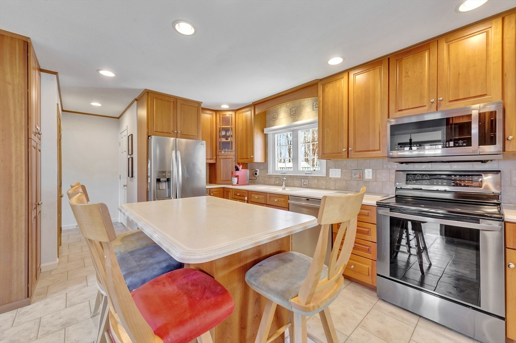 6 Blueberry Hill Road Groveland, MA 01834 - Photo 13 of 39 a kitchen with stainless steel appliances granite countertop a stove a sink a microwave and a refrigerator