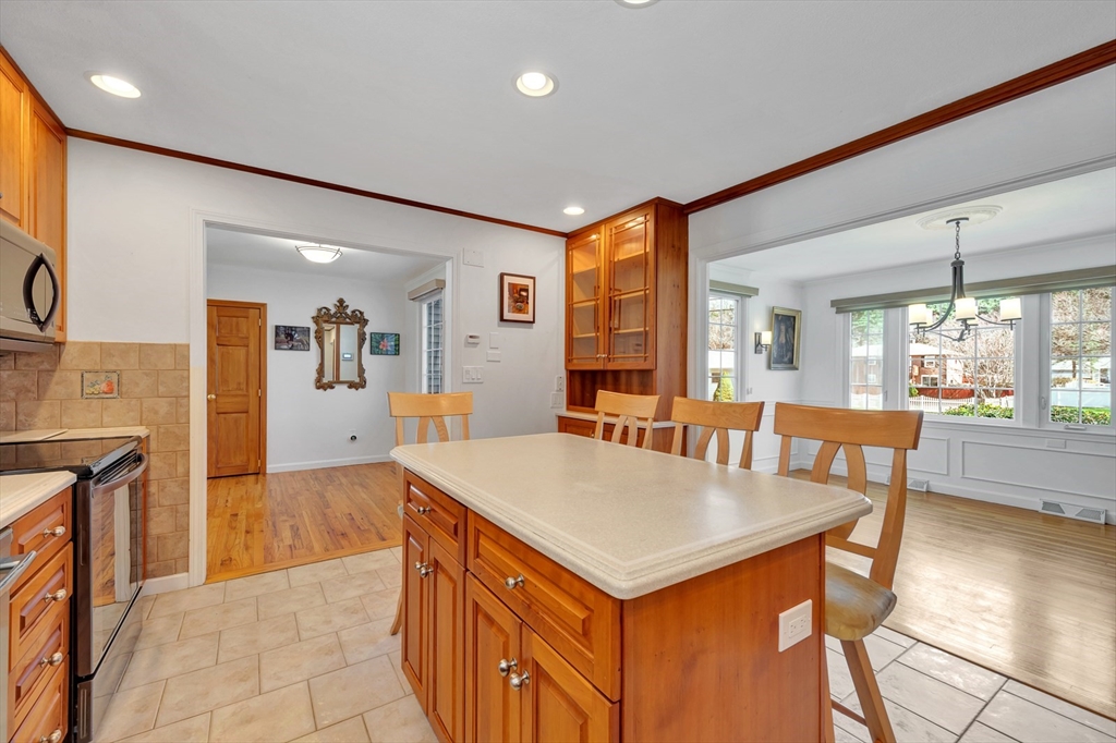 6 Blueberry Hill Road Groveland, MA 01834 - Photo 16 of 39 a view of kitchen island a sink wooden floor dining table and chairs