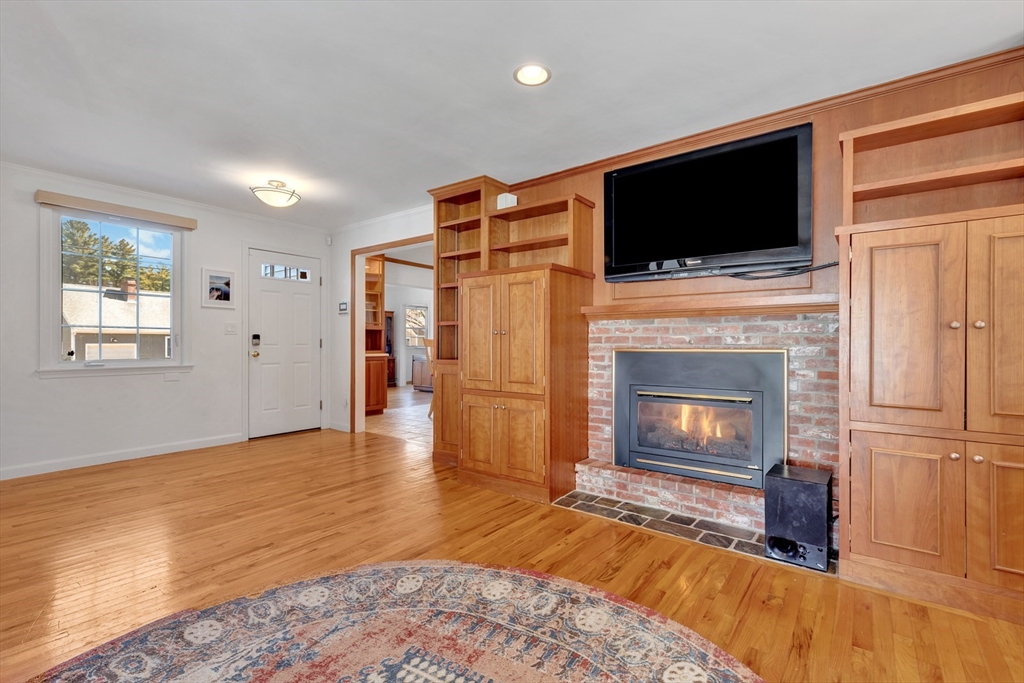 6 Blueberry Hill Road Groveland, MA 01834 - Photo 19 of 39 a living room with a fireplace and a television
