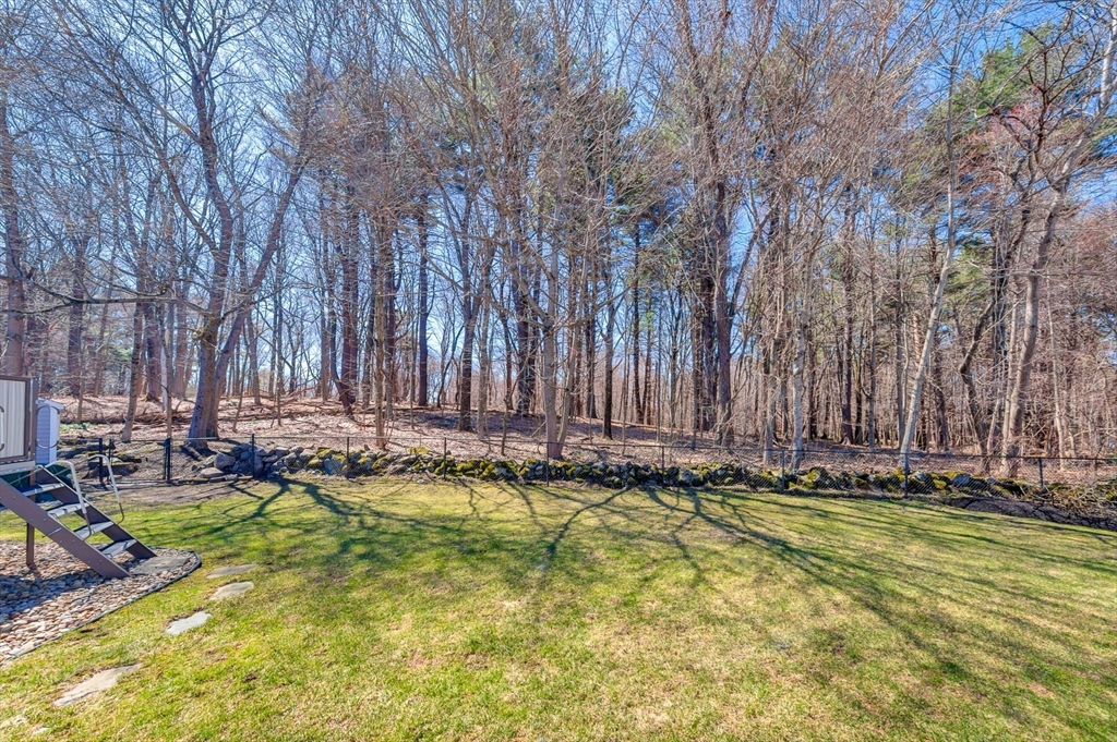 6 Blueberry Hill Road Groveland, MA 01834 - Photo 39 of 39 a view of swimming pool with lawn chairs and wooden fence