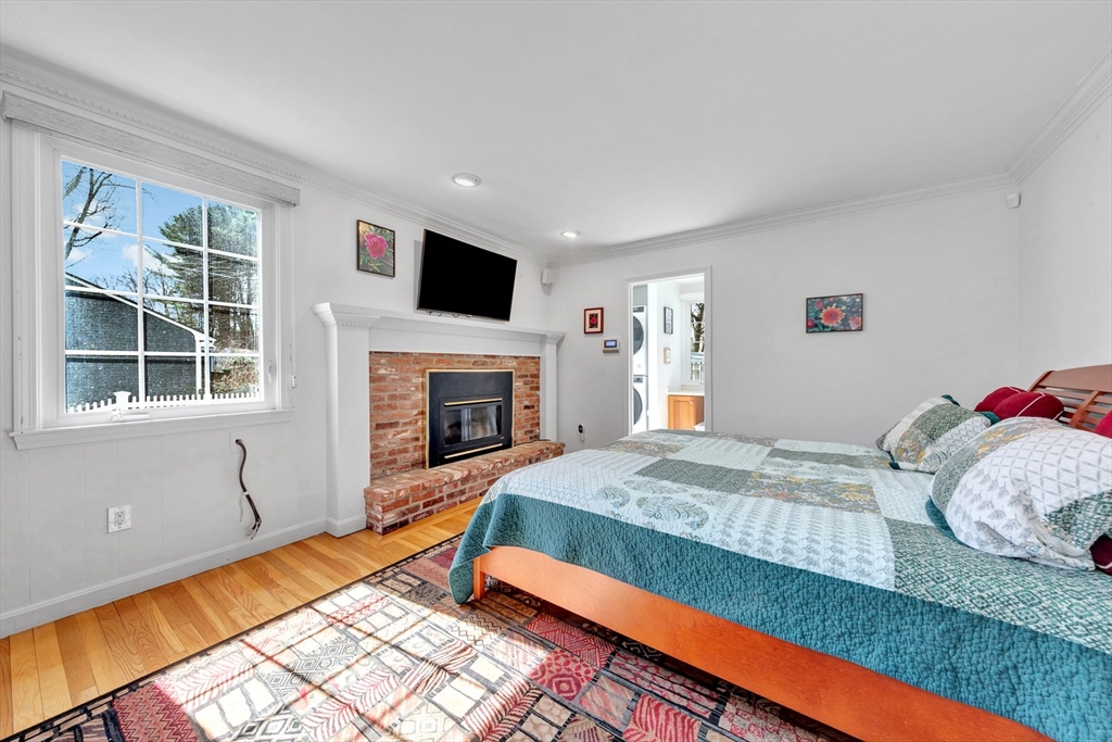 6 Blueberry Hill Road Groveland, MA 01834 - Photo 6 of 39 a bedroom with a bed and a fireplace