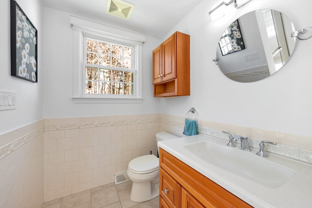 6 Blueberry Hill Road Groveland, MA 01834 - Photo 8 of 39 a bathroom with a granite countertop toilet sink and mirror
