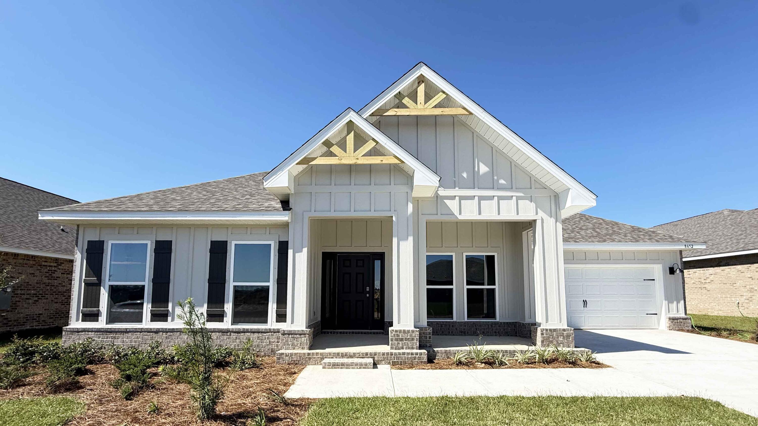 8652 Bluebell Street Milton, FL 32583 - Photo 1 of 25 a front view of a house with garden