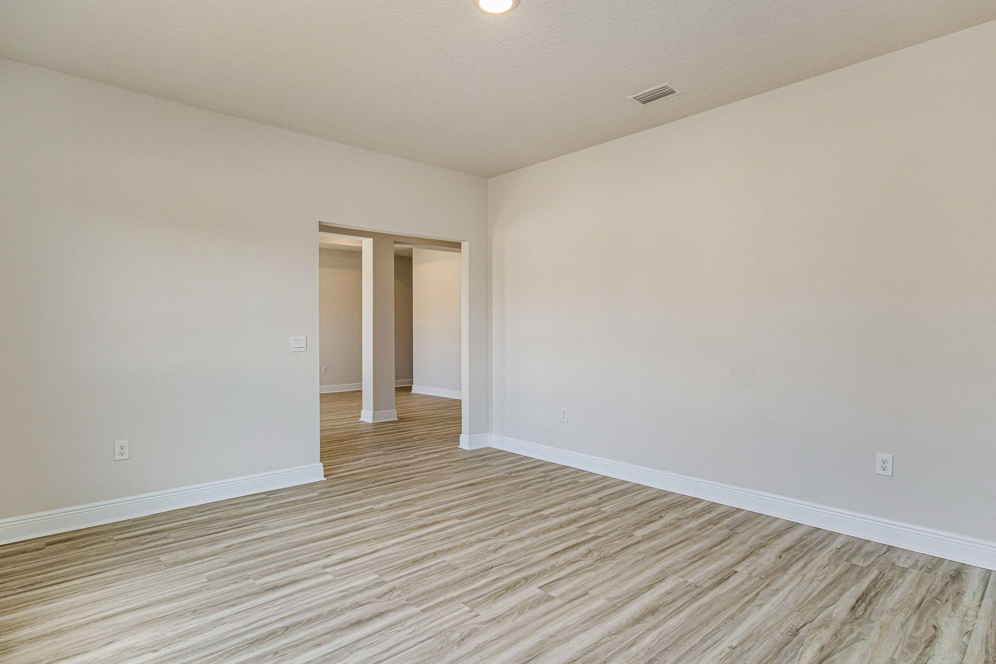 8652 Bluebell Street Milton, FL 32583 - Photo 15 of 25 a view of an empty room with wooden floor