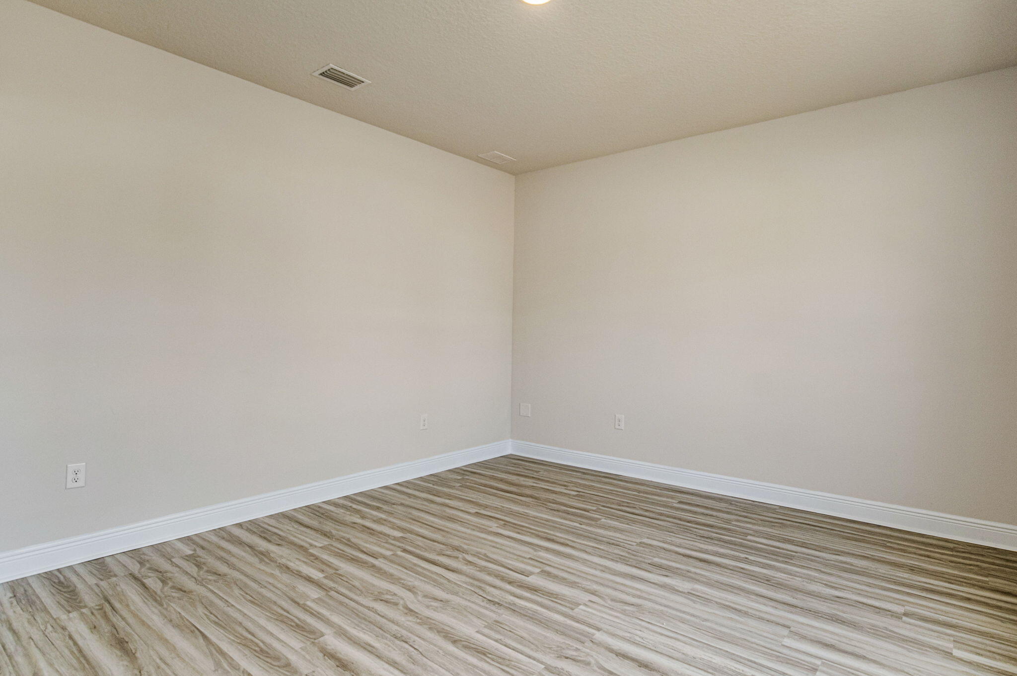 8652 Bluebell Street Milton, FL 32583 - Photo 20 of 25 a view of an empty room with wooden floor