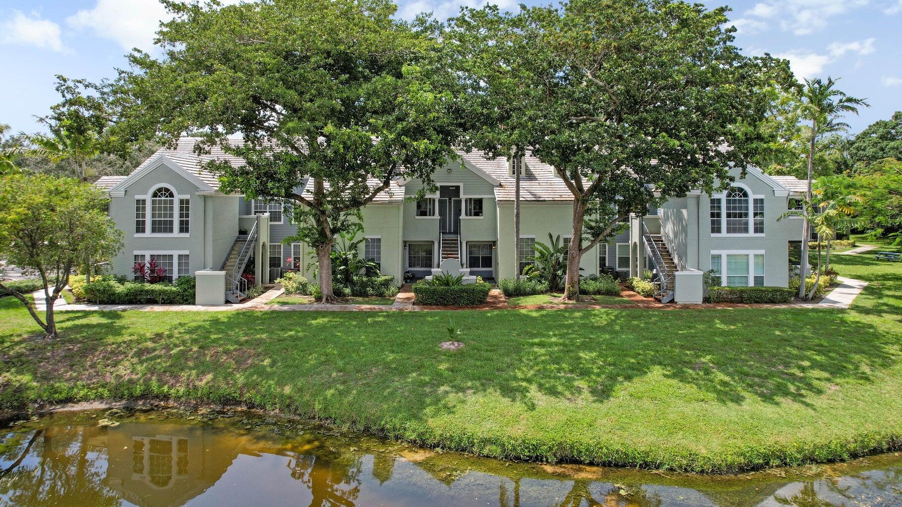 1050 Crystal Way, Unit L Delray Beach, FL 33444 - Photo 11 of 13 a front view of a house with garden