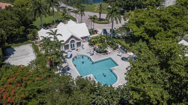 1050 Crystal Way, Unit L Delray Beach, FL 33444 - Photo 13 of 13 an aerial view of a house with a garden and trees