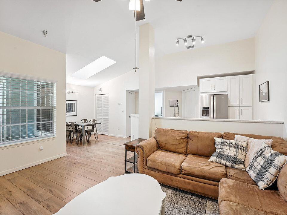 1050 Crystal Way, Unit L Delray Beach, FL 33444 - Photo 2 of 13 a living room with furniture and a large window