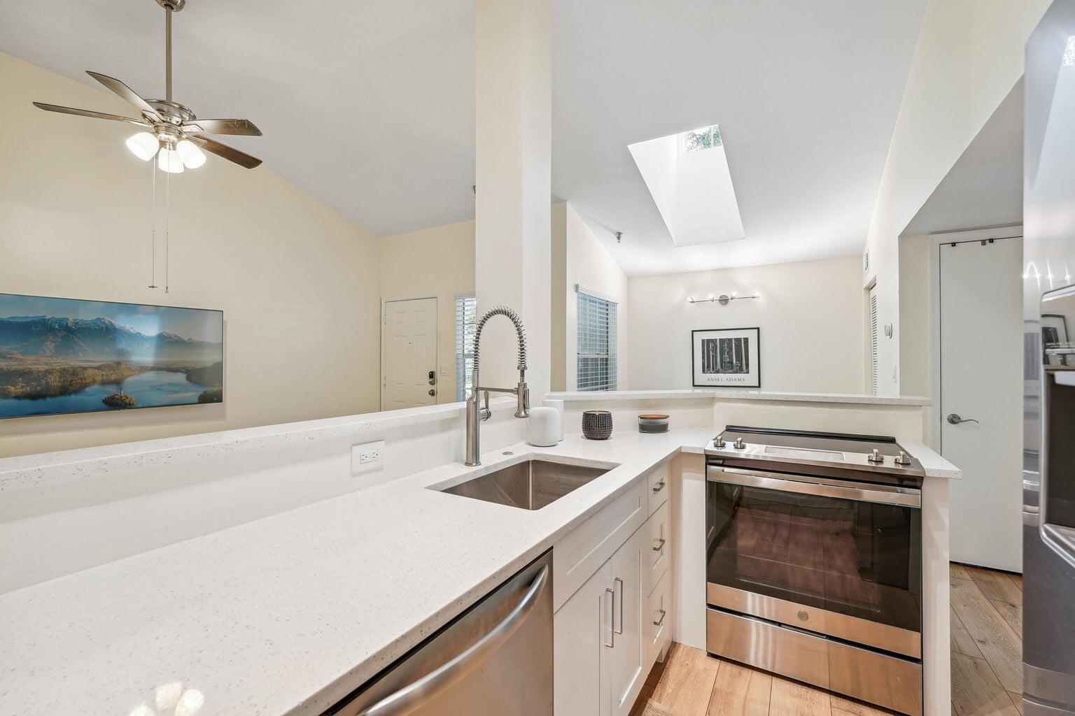 1050 Crystal Way, Unit L Delray Beach, FL 33444 - Photo 3 of 13 a kitchen with a stove and a sink