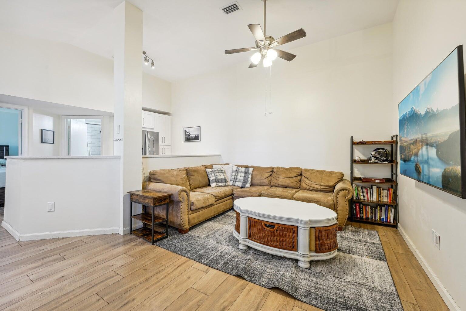 1050 Crystal Way, Unit L Delray Beach, FL 33444 - Photo 6 of 13 a living room with furniture and a chandelier