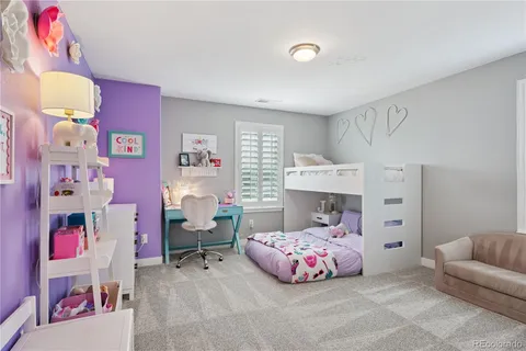 a bedroom with furniture and a baby crib