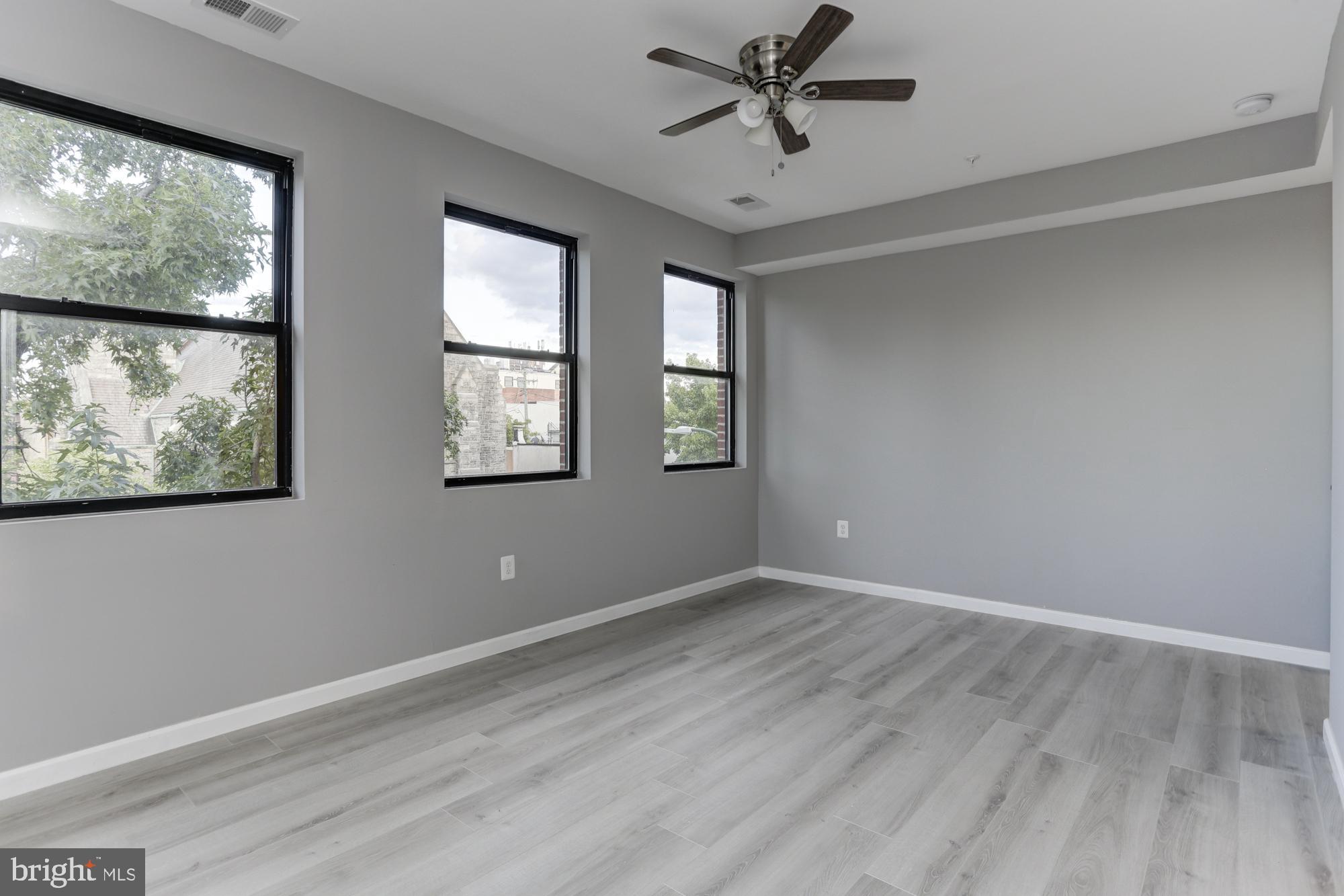 400 South Highland Avenue, Unit 301 Baltimore, MD 21224 - Photo 11 of 13 a view of an empty room with a window and wooden floor