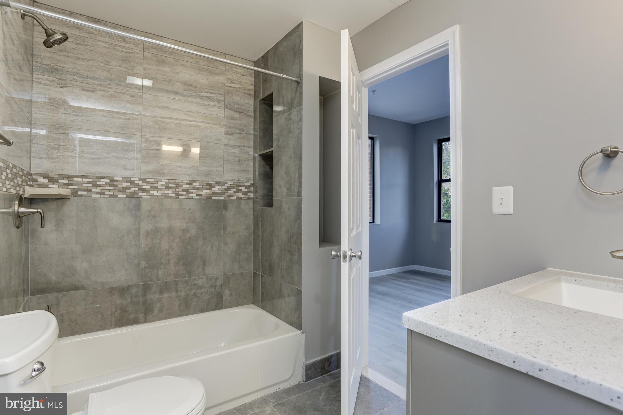 400 South Highland Avenue, Unit 301 Baltimore, MD 21224 - Photo 13 of 13 a bathroom with a bathtub toilet and shower