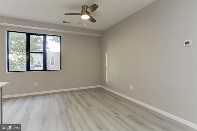 wooden floor in an empty room with a window