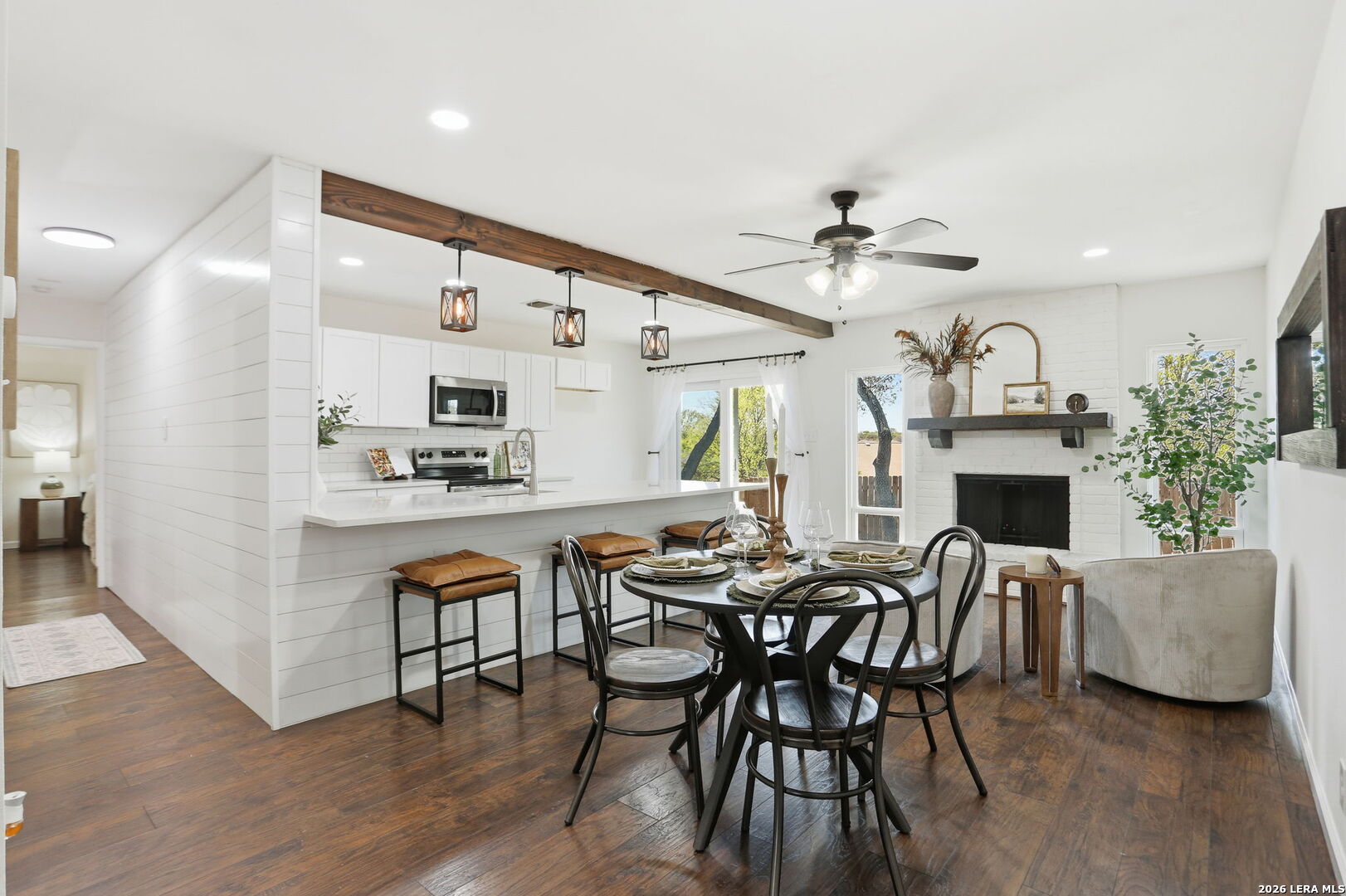 7106 Comanche Ridge Drive Converse, TX 78109 - Photo 15 of 36 a dining room with furniture and a fireplace with wooden floor