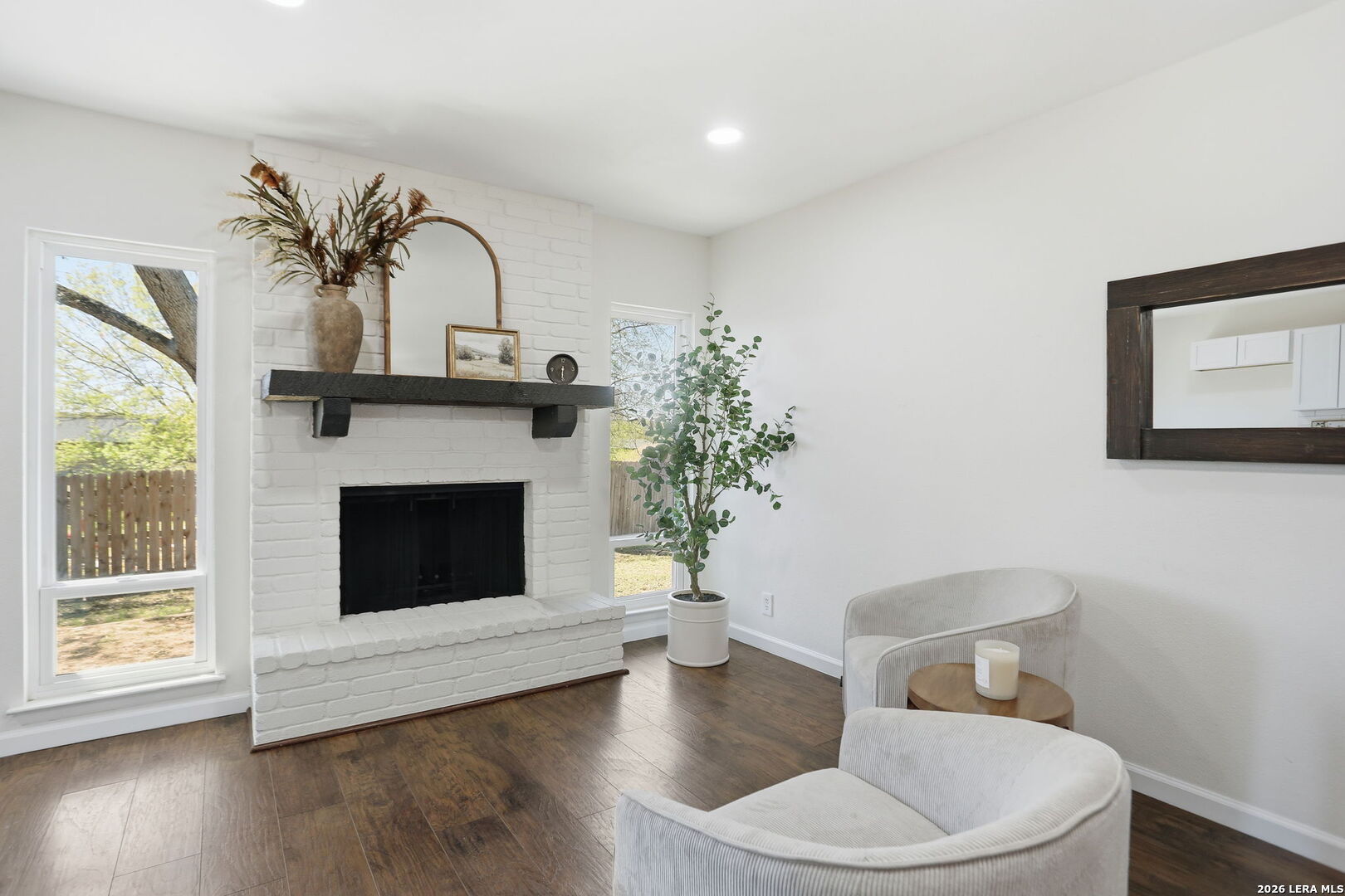 7106 Comanche Ridge Drive Converse, TX 78109 - Photo 19 of 36 a living room with a fireplace and a potted plant