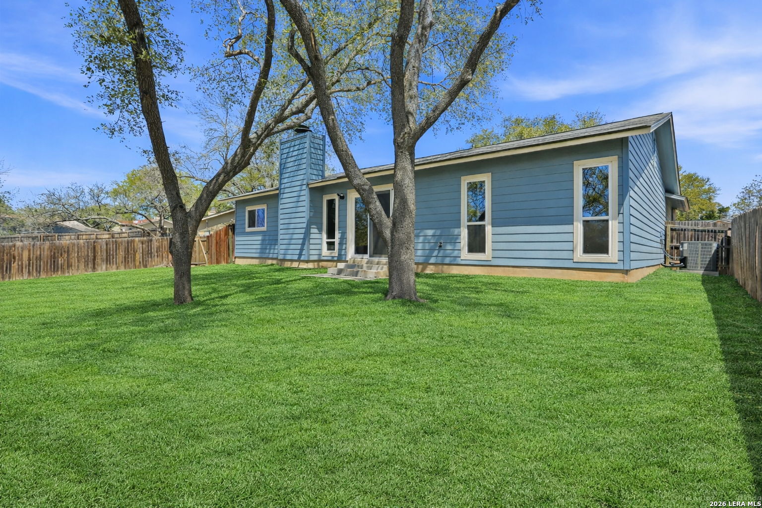 7106 Comanche Ridge Drive Converse, TX 78109 - Photo 36 of 36 a backyard of a house with wooden fence and large tree