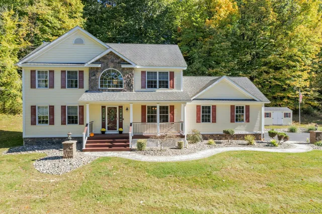 a front view of a house with a yard outdoor seating and yard