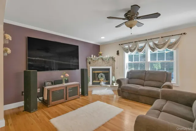 a living room with furniture a flat screen tv and a fireplace