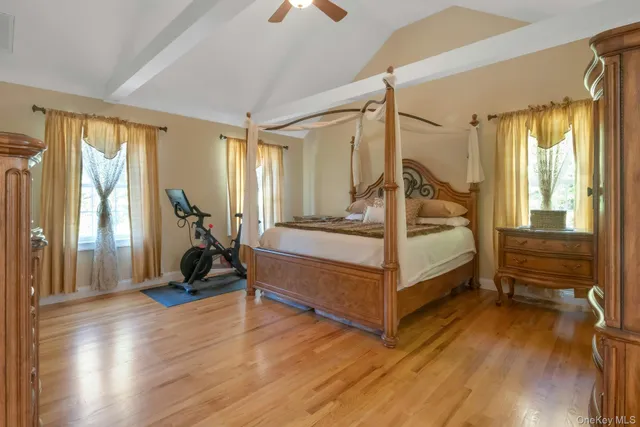 a view of bedroom with furniture and wooden floor