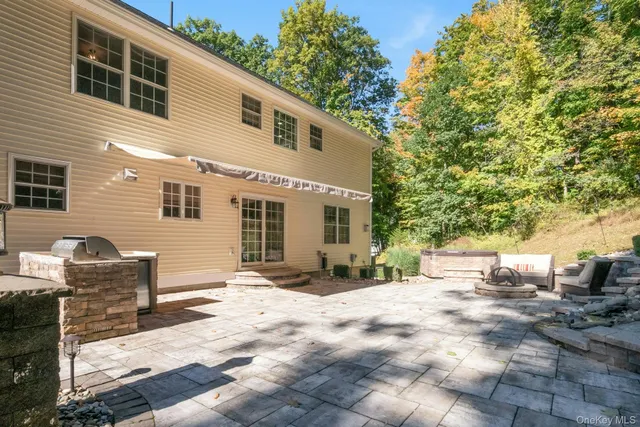 a backyard of a house with outdoor seating