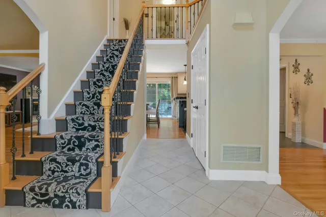 a view of a hallway with wooden floor and entryway