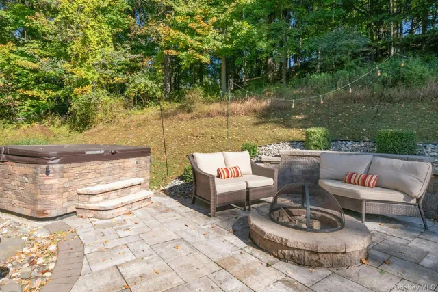a backyard of a house with fountain table and chairs