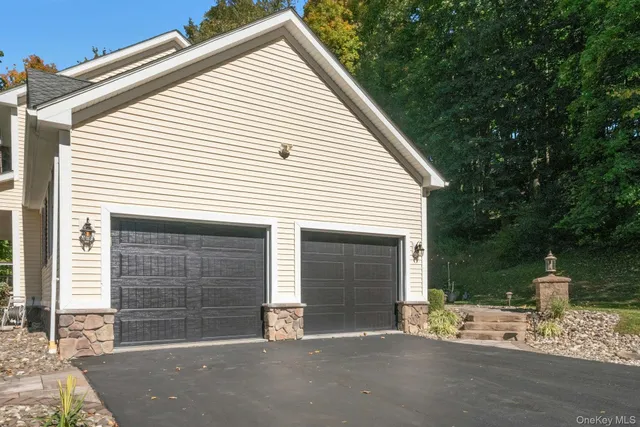a view of a small house with a garage