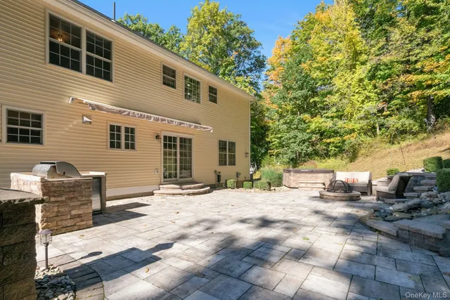 a backyard of a house with yard and outdoor seating