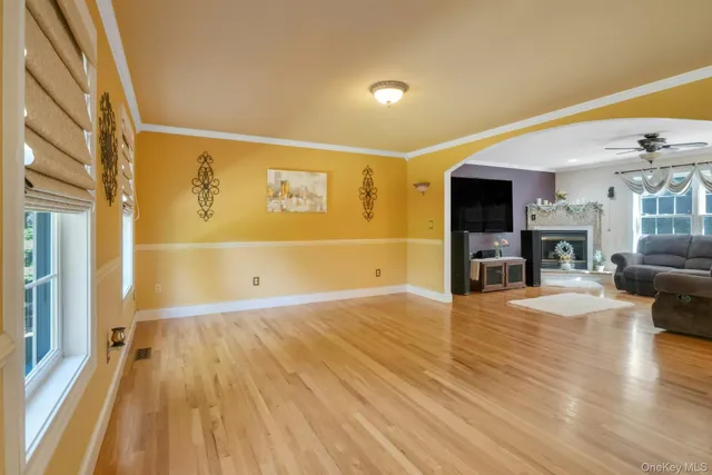 a view of a livingroom with wooden floor and a fireplace