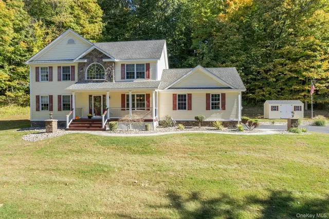 an aerial view of a house with swimming pool and patio