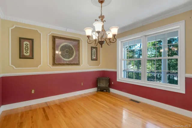 a view of a livingroom with a window and a chandelier