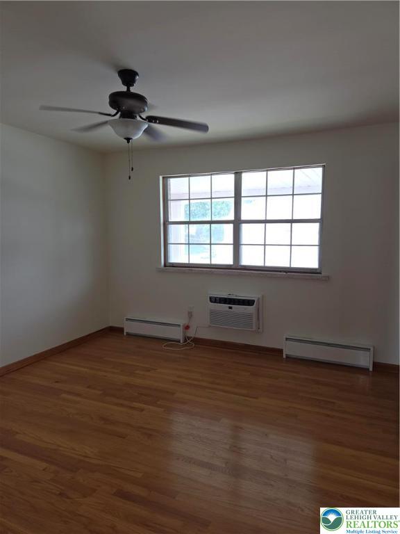 1204 Lewis Street, Unit 2E Bethlehem, PA 18017 - Photo 12 of 14 a view of an empty room with a window and wooden floor