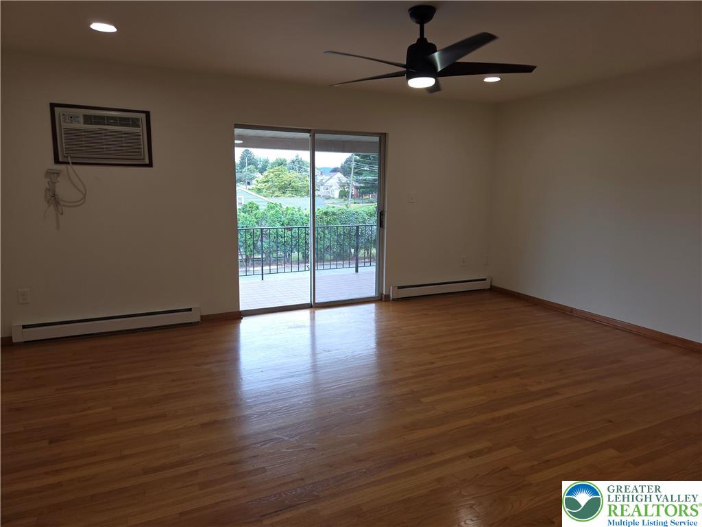 1204 Lewis Street, Unit 2E Bethlehem, PA 18017 - Photo 7 of 14 a view of an empty room with wooden floor and a window