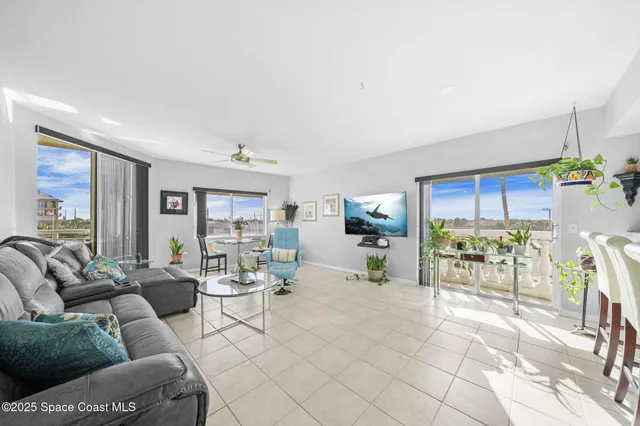 a spacious bedroom with a bed and a chandelier