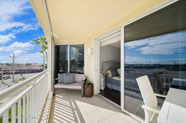 a bedroom with furniture and a large window