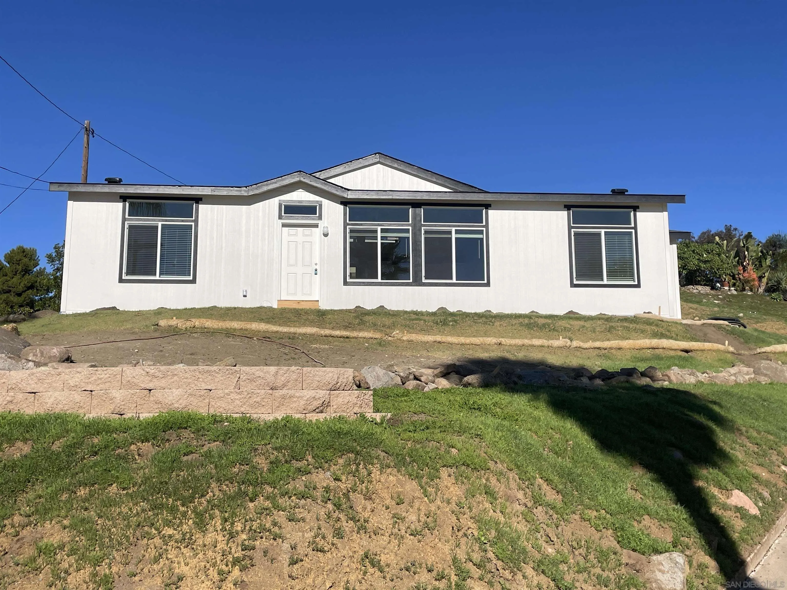 1255 Rhea Place, Unit B Vista, CA 92084 - Photo 2 of 13 a front view of a house with a yard