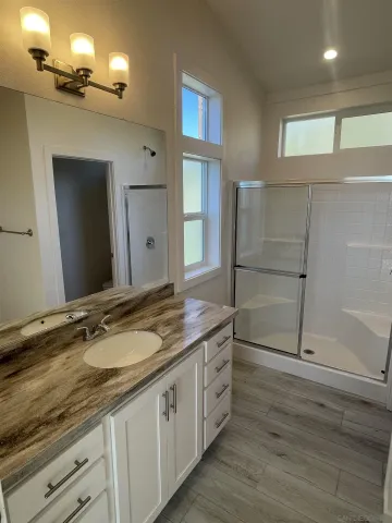 a spacious bathroom with double sink and a mirror