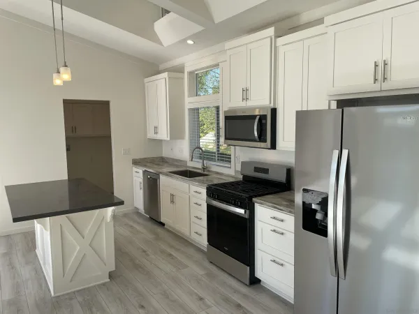 a kitchen with stainless steel appliances a refrigerator stove and microwave