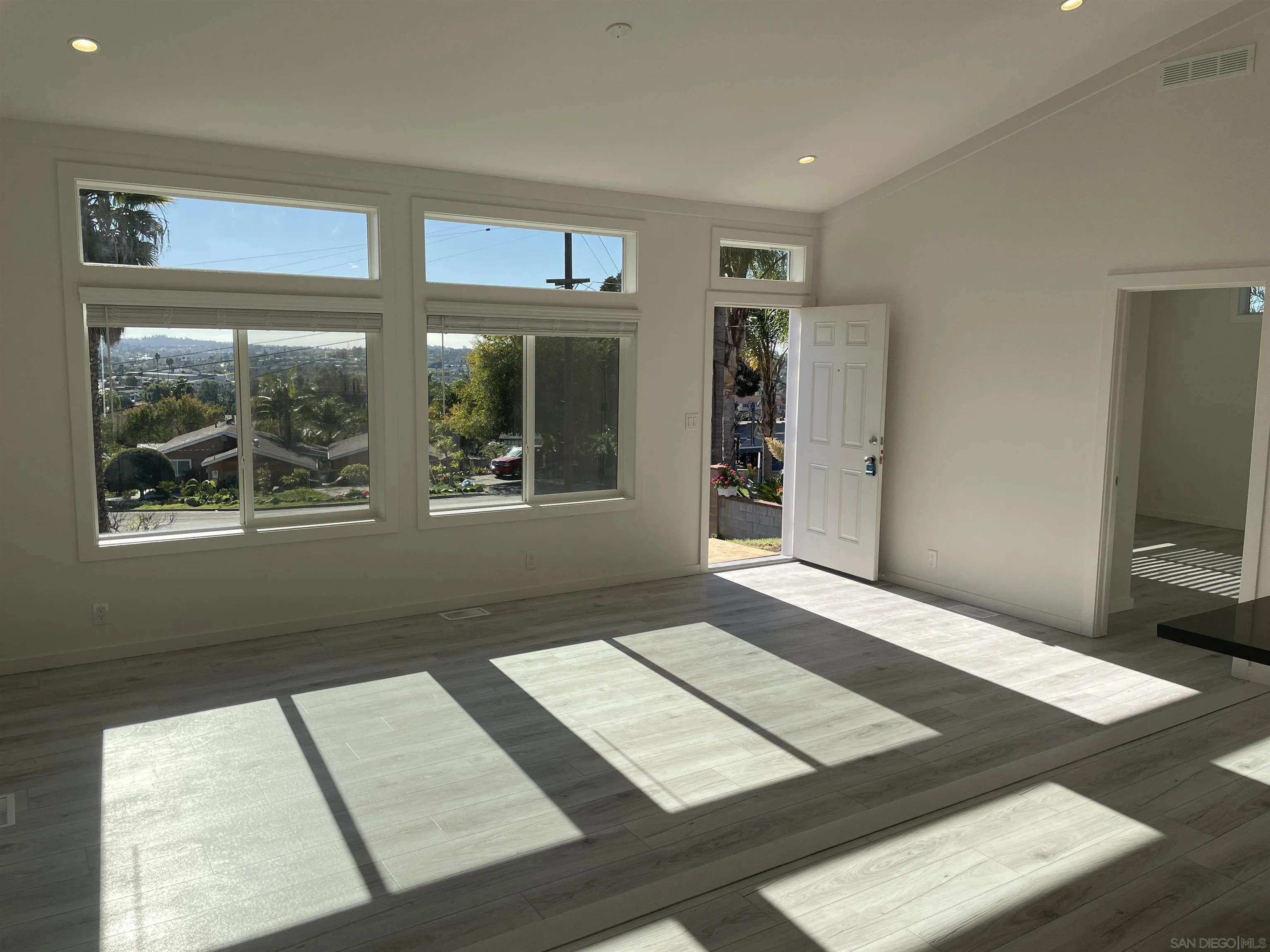 1255 Rhea Place, Unit B Vista, CA 92084 - Photo 9 of 13 a view of an empty room with wooden floor and a window