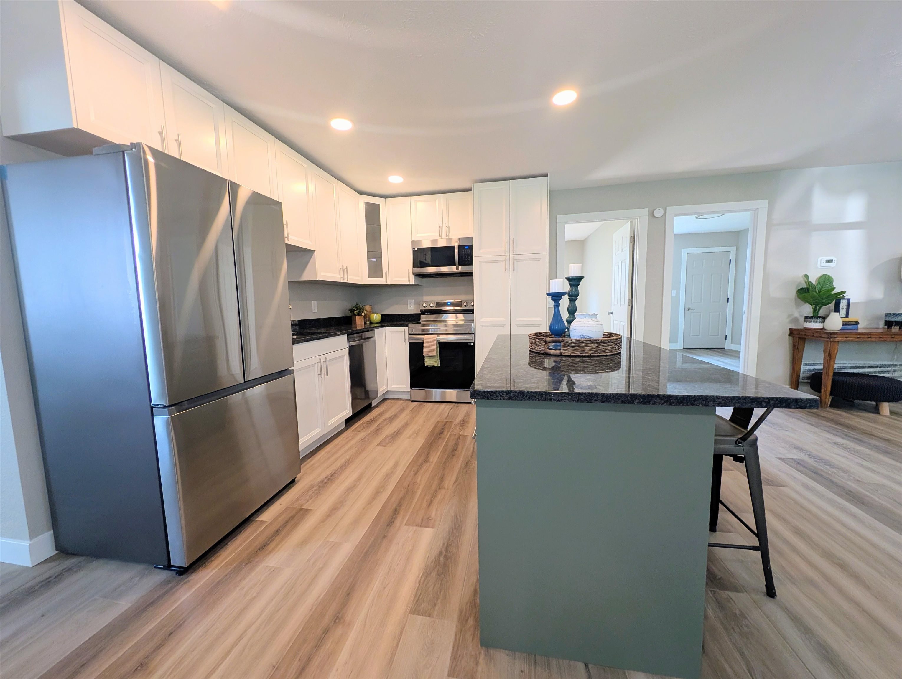 14202 Fritz Road Durand, IL 61024 - Photo 8 of 20 a kitchen with stainless steel appliances a refrigerator a stove a sink dishwasher and a refrigerator with wooden floor
