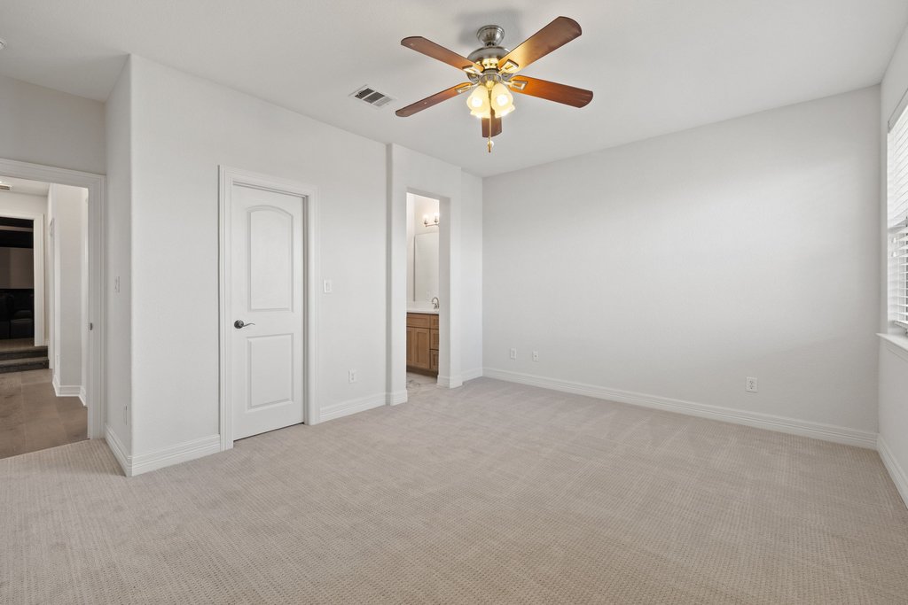 109 Largo Cove Austin, TX 78734 - Photo 25 of 40 A quiet bedroom retreat with plush carpeting, ready for personalized touches.