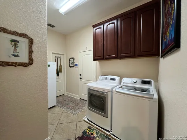 a view of a hallway with paintings on the wall
